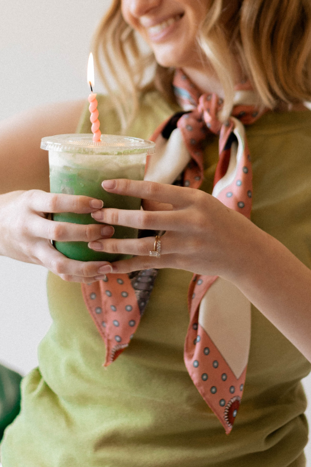 Hands holding an iced matcha latte